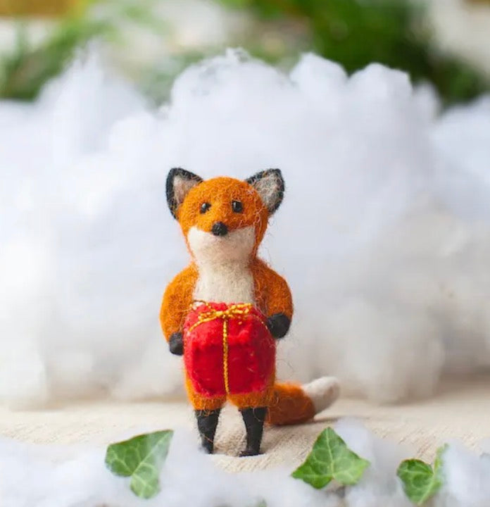 Rusty Fox Holding a Present