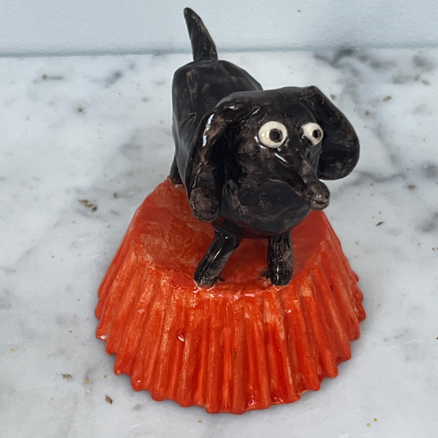 Little Brown Dog on Orange Stand