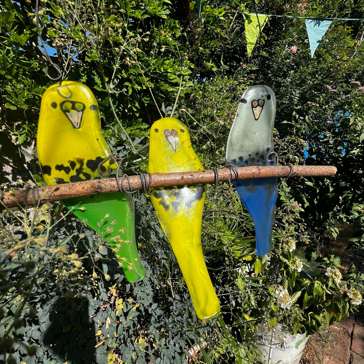Three Glass Budgies on a Perch