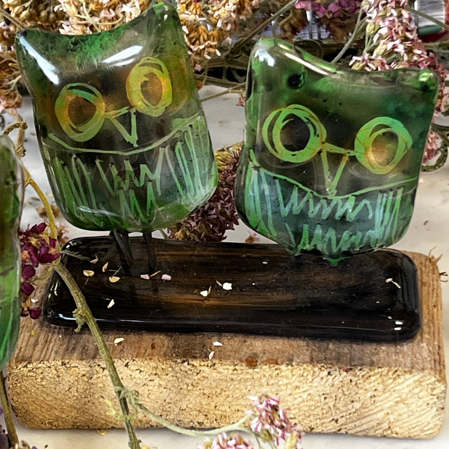Two Glass Owls on Wooden Stand